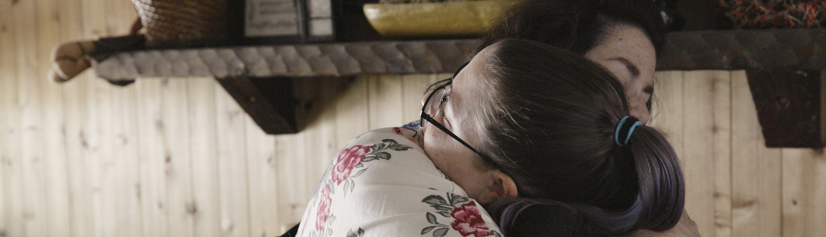 An aunt who provided kinship care embraces her niece who was in foster care. 